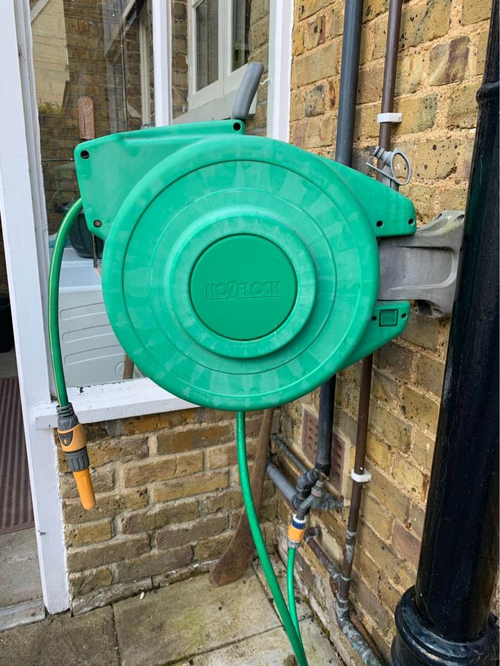 Comparing an automatic garden hose reel with a standard hose reel for